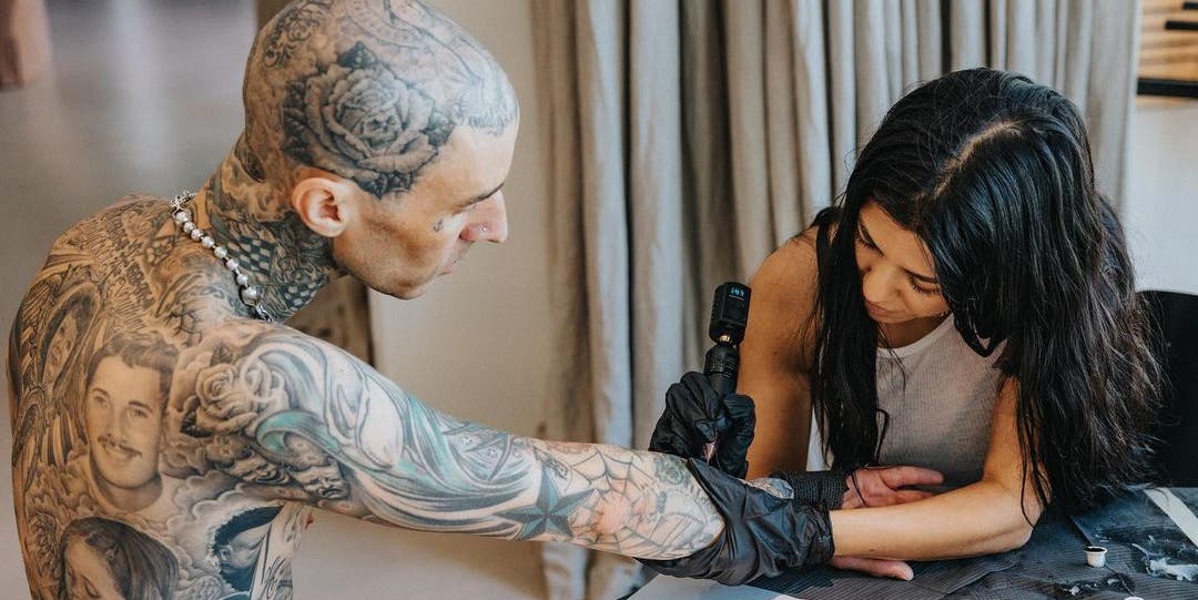 Oh, Nothing, Just Kourtney Kardashian Casually Tattooing "I Love You" on Travis Barker's Arm 1 Oh, Nothing, Just Kourtney Kardashian Casually Tattooing "I Love You" on Travis Barker's Arm