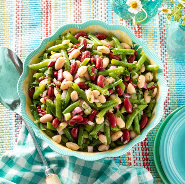 classic three bean salad recipe classic three bean salad in blue bowl with big spoon and flowers
