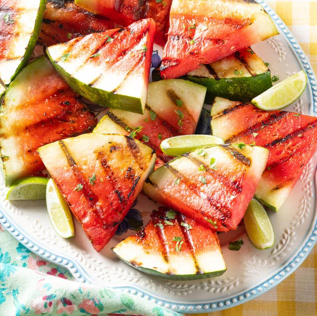 grilled watermelon recipe grilled watermelon with lime wedges on white platter
